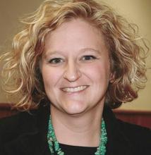 Photo headshot of Mindy; white, curly blonde hair,