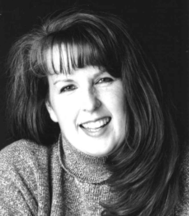 B&W Headshot of white woman with long hair and bangs with a turtleneck sweater